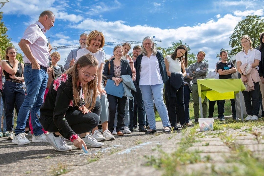 Ministerpräsidentin Malu Dreyer auf dem Außengelände der TH Bingen, umringt von Personen